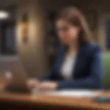 A young professional reviewing loan options on a laptop